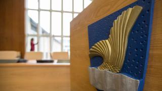 Vantaa official coat of arms and an angle view on the council hall.