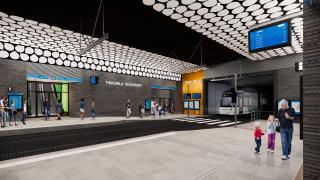 Havainnekuvassa ihmisiä maanalaisella ratikkapysäkillä.